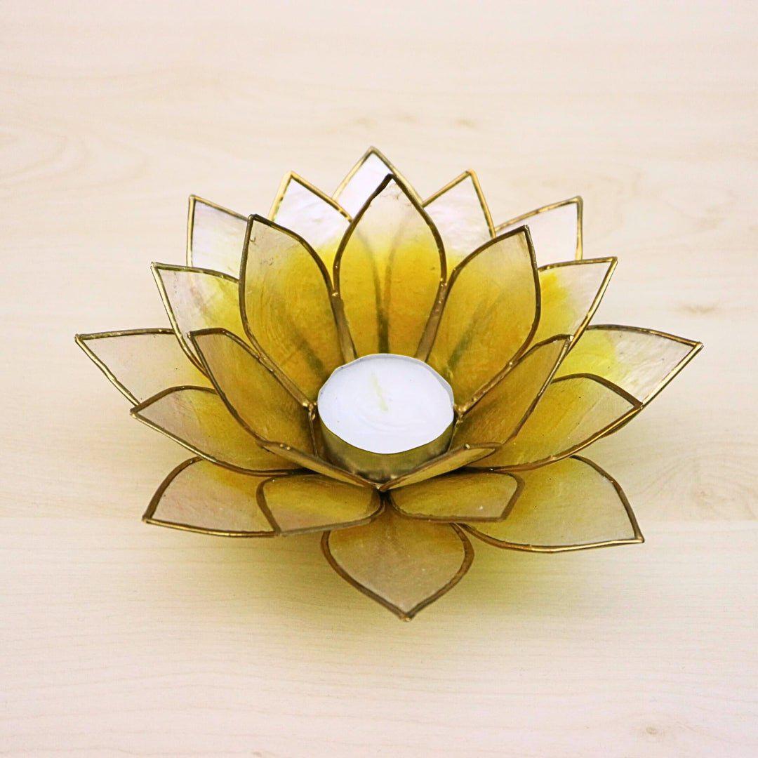 Handcrafted lotus-shaped capiz shell tealight holder in yellow and natural white, featuring delicate petals and a metal frame, creating a warm, ambient glow when lit