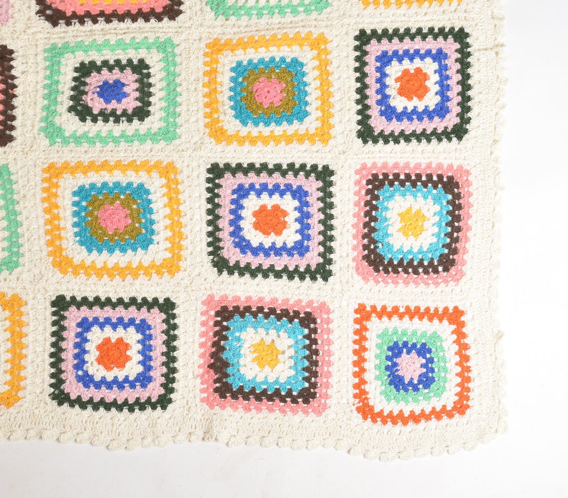 Handcrafted multicolor crochet granny square blanket throw featuring vibrant squares in various colors including orange, blue, green, and pink on a cream background, showcasing intricate stitching and traditional artisanal craftsmanship from Narsapur, India.