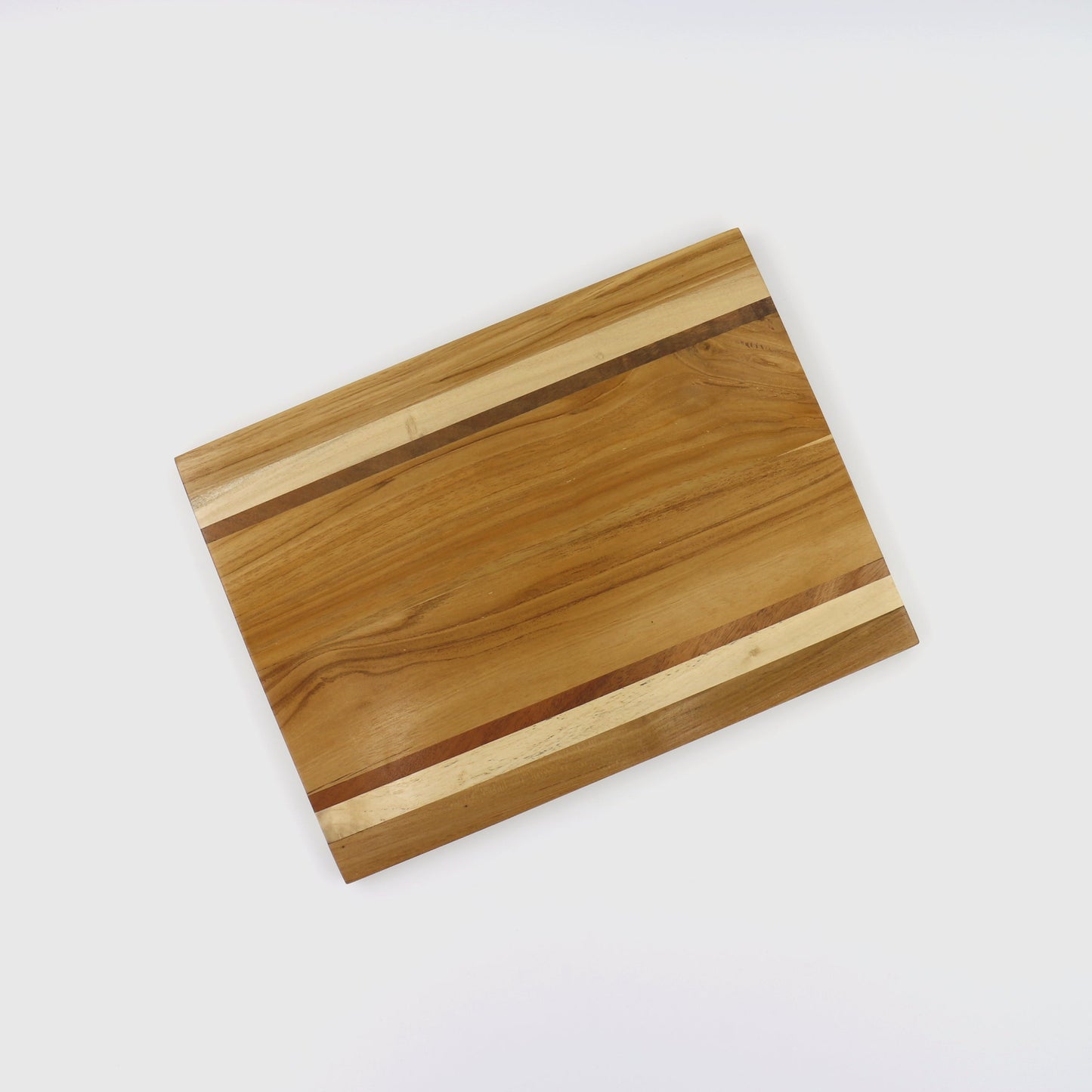 Eco-friendly edge grain cutting board made from reclaimed mixed wood scraps, featuring natural wood tones and a rectangular shape with visible grain patterns, suitable for serving and cutting food