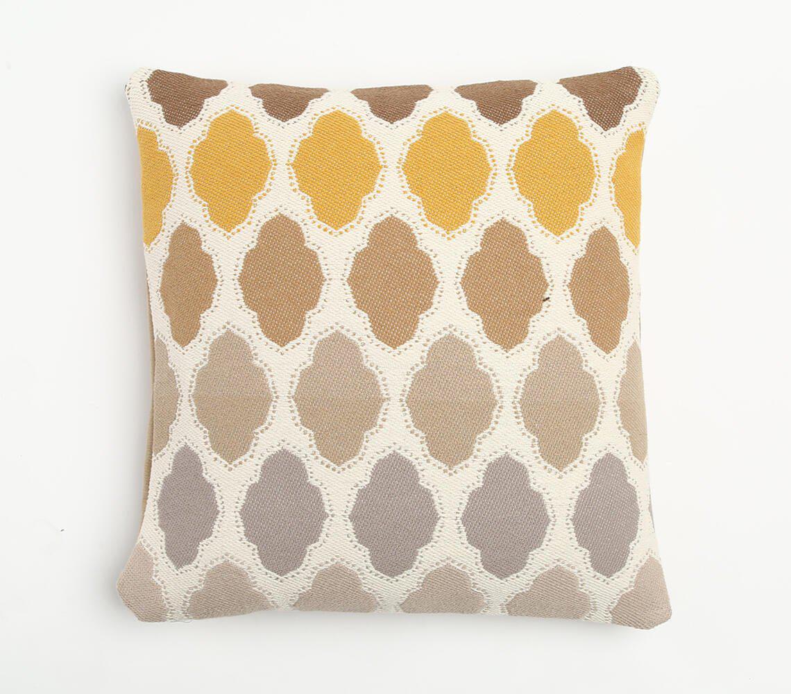 Geometric cushion cover with yellow, brown, and beige diamond-shaped pattern on white background, showcasing handcrafted artisanal texture and intricate weaving techniques for a stylish home decor accent