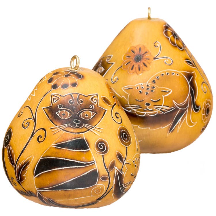 Handcrafted gourd ornaments featuring whimsical cat designs, carved and burned in traditional Peruvian style. Yellow-orange gourds with intricate black detailing of cat faces, flowers, and swirls. Unique, eco-friendly Christmas decorations for cat lovers.