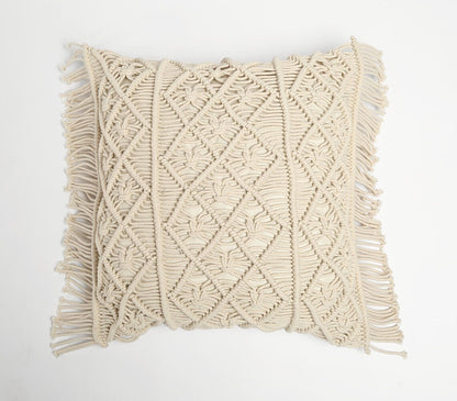 Handcrafted macrame cushion cover in natural white, featuring diamond pattern knotwork and fringe edges, showcasing bohemian style and artisanal craftsmanship for contemporary home decor.