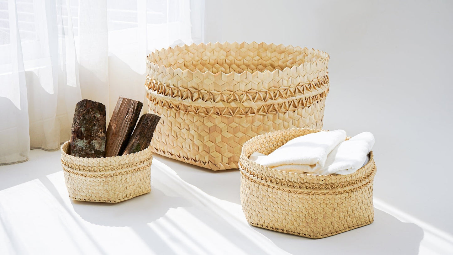 Handcrafted palm leaf storage baskets in various sizes, displaying intricate three-dimensional weaving patterns. Natural beige color, showcasing traditional Flores artisanship. Versatile containers for organizing fruits, snacks, or decorative items, adding rustic charm to home decor.