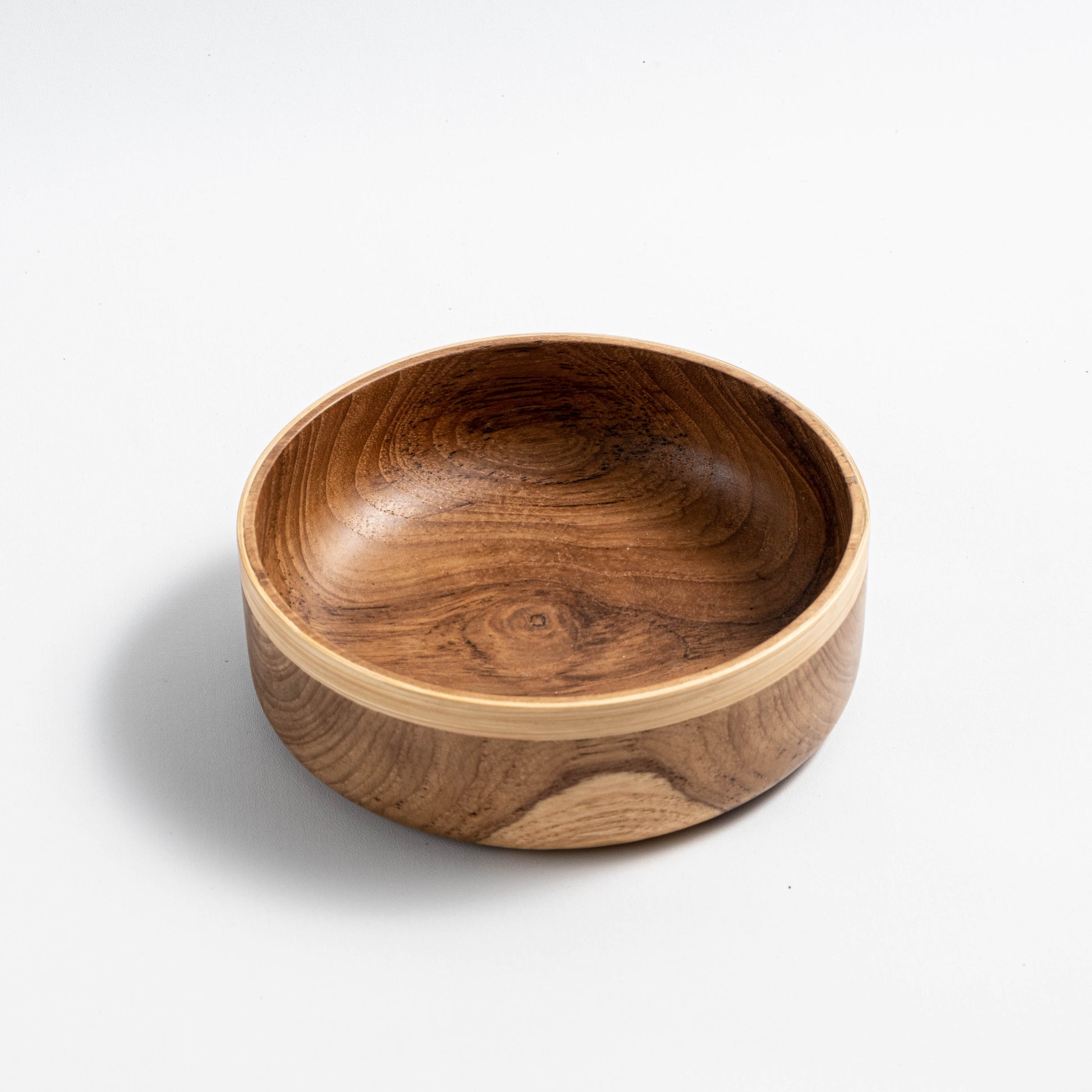 Handcrafted teak and bamboo salad bowl with minimalist design, featuring natural wood grain and sustainable materials, perfect for serving salads, pasta, or fruits in a stylish and eco-friendly manner